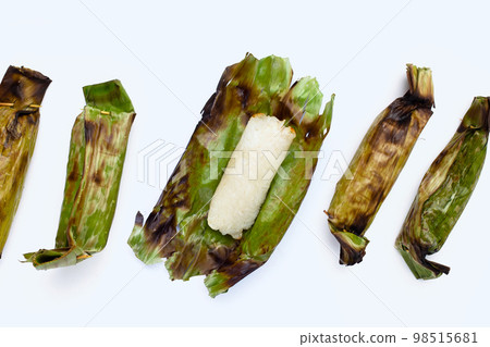 Grilled sticky rice in banana leaves with banana filling 98515681
