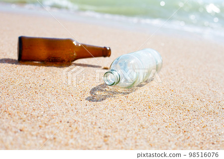Glass bottles on the beach Glass bottles on the beach 98516076