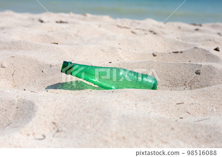 Green plastic bottle on the beach Green plastic bottle on the beach 98516088