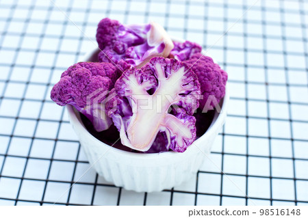 Purple cauliflower on white background. 98516148