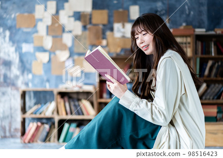 Young woman reading in a chic room 98516423