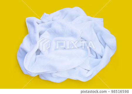 Used towel on yellow background. 98516598