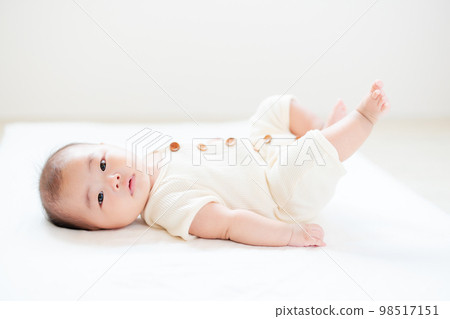 A baby in the sleeping period whose legs are becoming more active 3 months old 98517151