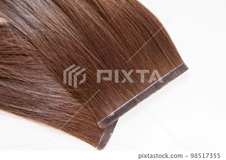 The process of preparing a hair ribbon for extension at home. The process of preparing a hair ribbon for extension at home. 98517355