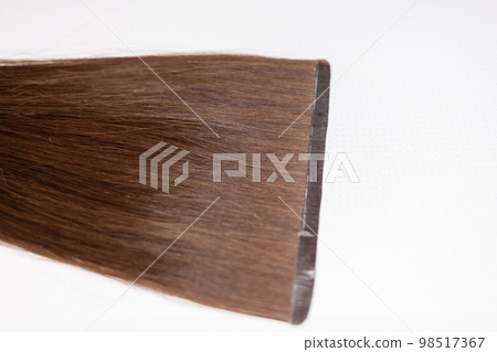The process of preparing a hair ribbon for extension at home. The process of preparing a hair ribbon for extension at home. 98517367
