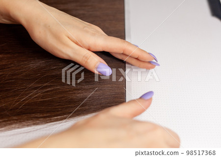 The process of preparing a hair ribbon for extension at home. 98517368
