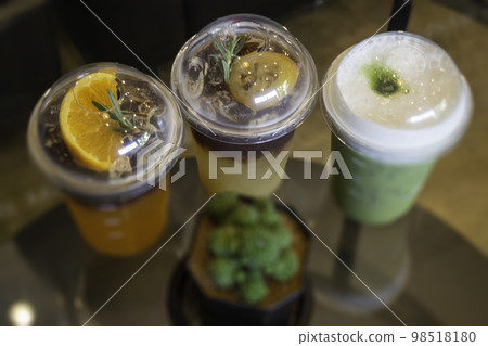 Glass of americano mixed with craft soda and yuzu orange juice Glass of americano mixed with craft soda and yuzu orange juice 98518180