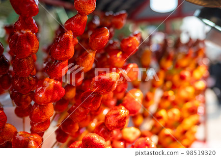 Tanghulu traditional Chinese hard caramel coated strawberry skewers close-up also called bing tanghulu candied hawthorn sticks Tanghulu traditional Chinese hard caramel coated strawberry skewers close-up also called bing tanghulu candied hawthorn sticks 98519320