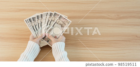 Woman hand counting Japanese Yen banknote over table background. Thousand Yen money. Japan cash, Tax, Recession Economy, Inflation, Investment, finance, savings, salary and payment concepts Woman hand counting Japanese Yen banknote over table background. Thousand Yen money. Japan cash, Tax, Recession Economy, Inflation, Investment, finance, savings, salary and payment concepts 98519511