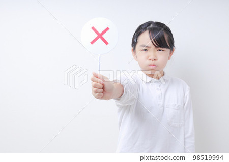 A female elementary school student with an angry face sticking out a ✖️ tag 98519994