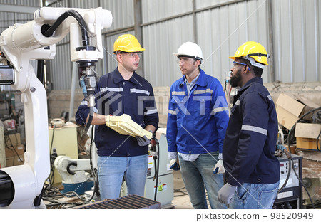 engineer teaching robot welding machine , he explanation how to working of robot arm , all function is controlled by remote engineer teaching robot welding machine , he explanation how to working of robot arm , all function is controlled by remote 98520949