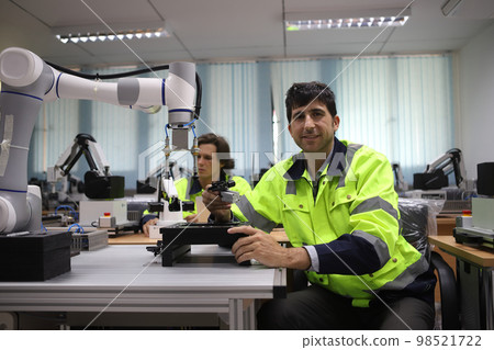 engineer teaching robot welding machine , he explanation how to working of robot arm , all function is controlled by remote 98521722