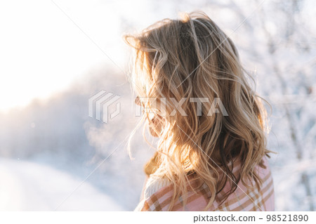 Portrait of smiling blonde woman with blonde hair in winter clothes in snowy winter forest Portrait of smiling blonde woman with blonde hair in winter clothes in snowy winter forest 98521890
