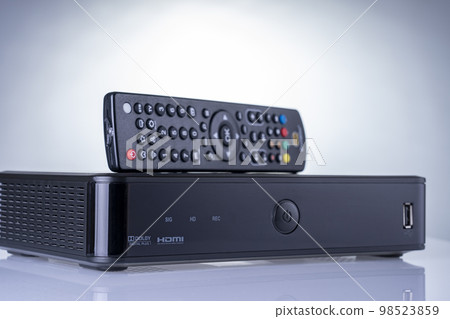 TV set-top box prepared for installation, digital TV kit on white background close-up with reflection 98523859