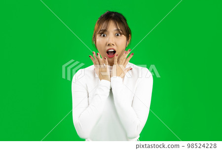 Young Asian woman eith surprised face isolated on green screen. 98524228