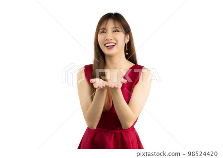 Young beautiful asian woman long hair style wear red dress posing smiling and hands pointing to you white backgtound. Young beautiful asian woman long hair style wear red dress posing smiling and hands pointing to you white backgtound. 98524420