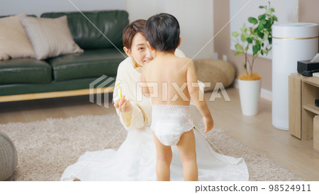 Mother brushing her 2-year-old son's teeth 98524911