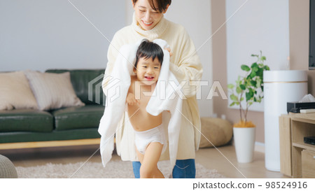 Mother blowing up her 2-year-old son's hair 98524916