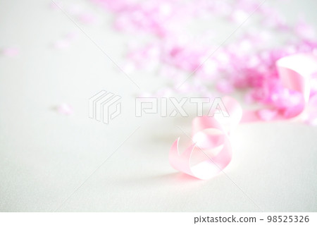 Spring graduation, new school, new member of society, celebration image, cherry blossom petals and ribbon 98525326
