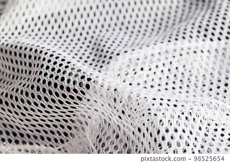 White lining in clothes in a hole, macro. Textured White lining in clothes in a hole, macro. Textured 98525654