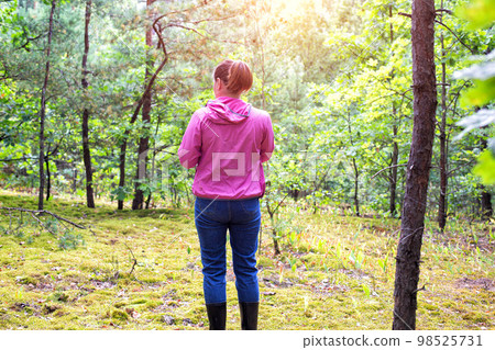 A girl in a pink sweater got lost in the forest in the summer. Location orientation. Survival in the forest. A girl in a pink sweater got lost in the forest in the summer. Location orientation. Survival in the forest. 98525731