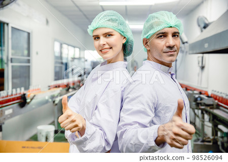 portrait team staff worker in food and drink industry production line beverage factory happy smiling 98526094