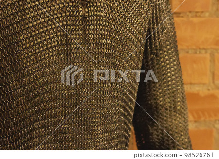 Protective old military chain mail, close-up. Mail made of round metal rods for the protection of a warrior. 98526761