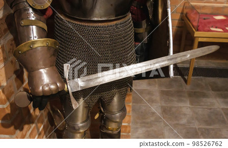 The knight in his hand holds a sword and shield. Protecting warriors during battle in ancient times, close-up 98526762