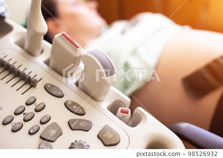 Pregnant girl on ultrasound examination in the third trimester. Examination of the amount of amniotic fluid, entanglement of the umbilical cord of the child. Copy space for text Pregnant girl on ultrasound examination in the third trimester. Examination of the amount of amniotic fluid, entanglement of the umbilical cord of the child. Copy space for text 98526932