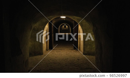 First person view walking through the military tunnel in the dungeon. Defensive structure, casemates. Bomb shelter during the war. Copy space for text 98526997