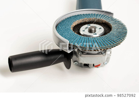 Professional angle grinder with flap wheel for processing wooden surfaces. Construction power tool. Industry, close-up 98527092