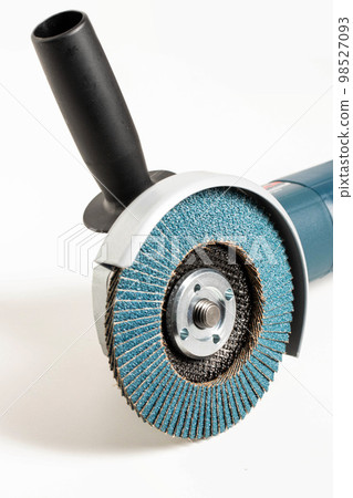 Professional angle grinder with flap wheel for processing wooden surfaces. Construction power tool. Industry, close-up Professional angle grinder with flap wheel for processing wooden surfaces. Construction power tool. Industry, close-up 98527093