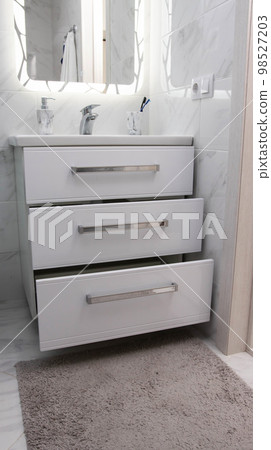 Modern bathroom vanity with pull-out drawers and moisture protection. Modern bathroom vanity with pull-out drawers and moisture protection. 98527203