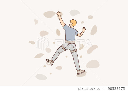 Man climbs on a climbing wall in a climbing gym isolated Man climbs on a climbing wall in a climbing gym isolated 98528675