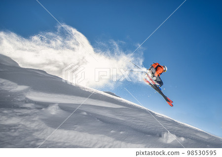 Skier in the sky during a jump Skier in the sky during a jump 98530595