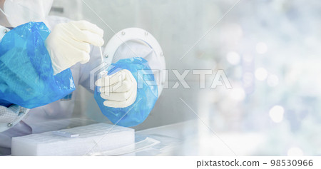 Close up to the rubber gloves on the asian medical staff is processing coronavirus or covid-19 test in the negative room pressure. Close up to the rubber gloves on the asian medical staff is processing coronavirus or covid-19 test in the negative room pressure. 98530966