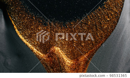Glitter fluid. Abstract background. Sparkling wave. Defocused shimmering metallic bronze gold silver gray black color liquid paint grain texture. 98531365