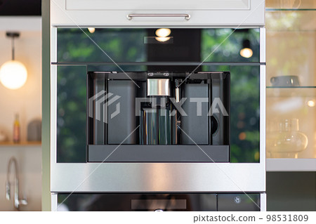Contemporary and modern Coffee machine building furniture in the kitchen. 98531809