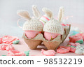 Happy Easter holiday concept with cute handmade eggs, knitted bunny hats and sweet pink decor, copy space. Greeting card, banner for your site, flyer, banner, invitation, discount card 98532219