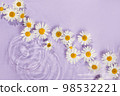 Daisy flower floating in the circular waves turquoise splashing water. Creative floral, skin care concept. Minimal spa natural composition, eco organic cosmetic. Spring or summertime idea. 98532221