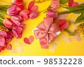 Romantic background with bouquet of tulips and gift boxes on yellow. Top view with copy space. Mother's Day, 8 march, Saint Valentine day background, greeting card 98532228
