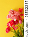 Greeting card. Bouquet of colorful tulip flowers gift box on yellow, copy space, invitation card. Spring time seasonal holiday, 8 march International woman day, Mother day, banner 98532237
