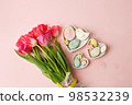 Easter floral background, various gingerbread glazed cookies end decorated with natural botanical elements on pink, flat lay, view from above, blank space for greeting text, banner, flyer, coupon 98532239