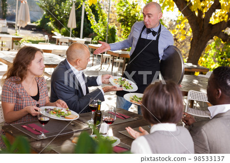 Conflict between waiter and client in the open-air restaurant Conflict between waiter and client in the open-air restaurant 98533137