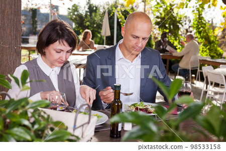 Adult couple having lunch at summer cafe terrace 98533158