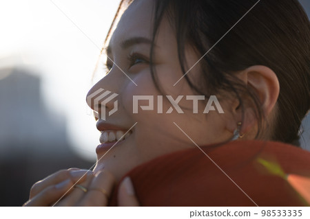 Young woman portrait (outdoors, muffler 98533335