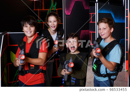 teen kids with laser guns during lasertag game 98533455