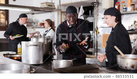 Chef male dissatisfied with the work of girl helper Chef male dissatisfied with the work of girl helper 98533531