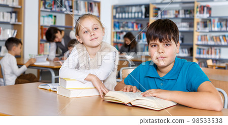 School friends reading books in library 98533538
