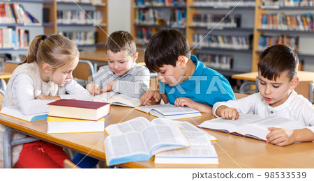 Children studying in school library Children studying in school library 98533539